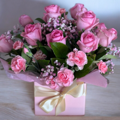 LOVE YOU - Quality  stems of pink roses and carnations set a container with foam and water. Pretty foliage and wrappings.